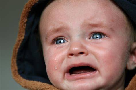 Crying Baby in Brown and Black Hooded Top · Free Stock Photo