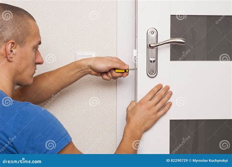 Repair door lock stock image. Image of indoors, male - 82290729