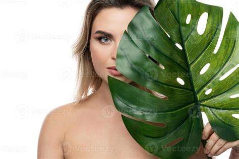 Beautiful caucasian woman with a smooth skin holding green tropical leaf 16291886 Stock Photo at ...