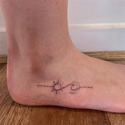Minimalist sun, moon and wave tattoo on the foot