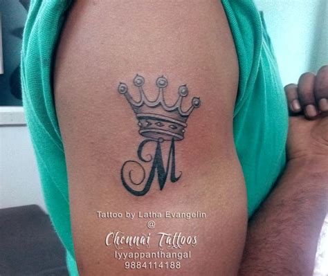 a man with a crown tattoo on his arm