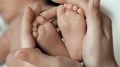 close-up-of-little-baby-feet-in-hands-of-unrecognizable-mother_njvzpbyng__F0000 - Goodfullness