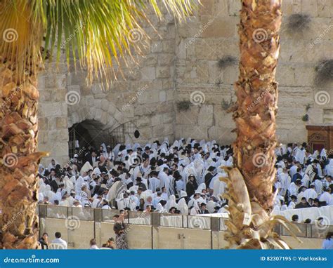 A Crowd of People Praying To God at the Wailing Wall of Jerusalem with Two Palms Trees on the ...