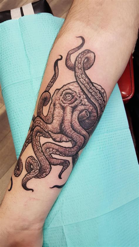 an octopus tattoo on the arm