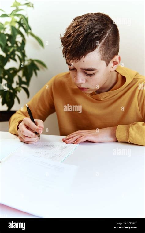 Teenage boy writing homework at home. Education concept Stock Photo - Alamy