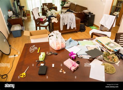 Messy living room with clothes and other stuff Stock Photo - Alamy