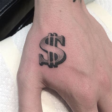 a hand with a dollar sign tattoo on it