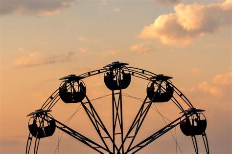 Premium Photo | Red sunset with ferris wheel silhouette