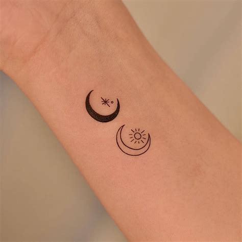 Minimalist sun and moon tattoo on the wrist