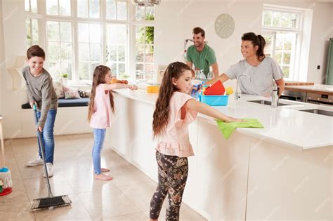 Premium Photo | Children Helping Parents With Household Chores In Kitchen