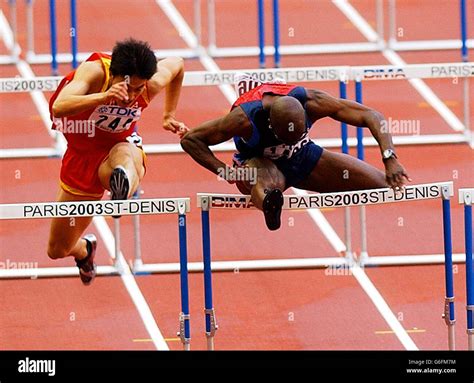 Allen Johnson of the USA (right) clears the final hurdle ahead of Liu Xiang of China to win the ...