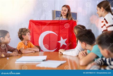 Female Teacher Working with Teenage Students in School Class, Talking about National Flag of ...