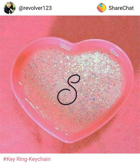 a pink heart shaped container filled with glitter and the letter s on it's side