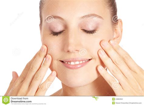 Woman Applying Lotion To Her Face Stock Photo - Image of face, cream: 24862952