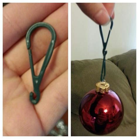 a hand holding a red ornament and a pair of green scissor