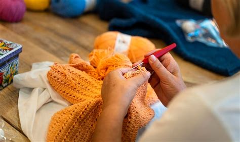 Premium Photo | Crochet club Closeup of an elderly woman's hands knitting