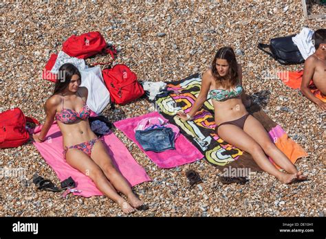 England, East Sussex, Brighton, Brighton Beach, Girls Sunbathing on Stock Photo, Royalty Free ...