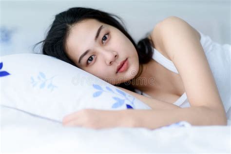 Young woman lay on a bed stock image. Image of comfort - 206889437