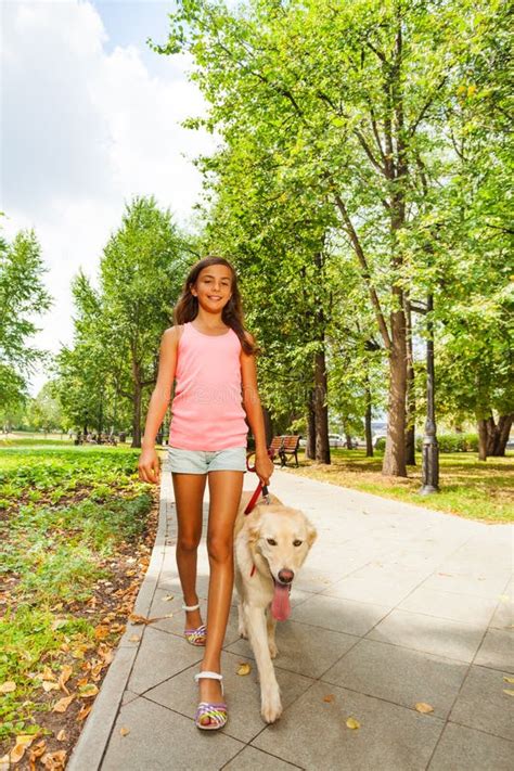 Nice Teenage Girl Walk Her Dog In Park Alley Stock Photo - Image: 44101353