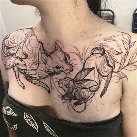 Abstract style black ink fox with little rabbit tattoo on chest ...