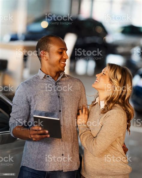 Happy Diverse Couple Talking While Using Touchpad In A Car Showroom Stock Photo - Download Image ...