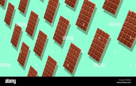 Pattern of many whole milk chocolate tablets with shadows on cyan background, viewed in ...