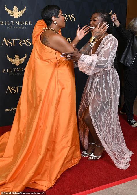 Fantasia Barrino wows in billowing orange gown as she joins stars at the 7th Astra Film Awards ...