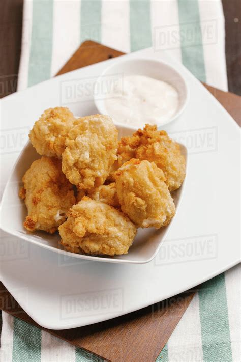 Chicken nuggets and dipping sauce - Stock Photo - Dissolve