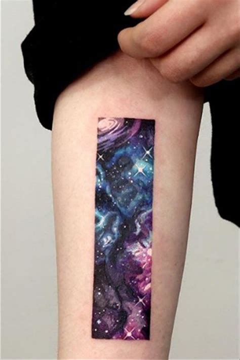 a woman's arm with a small space themed tattoo on the left side of her arm