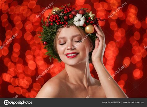 Beautiful young woman wearing Christmas wreath on blurred background. Bokeh effect Stock Photo ...