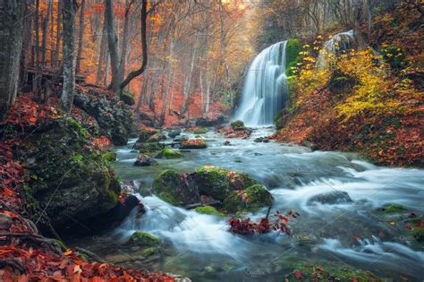 Beautiful waterfall in autumn forest | High-Quality Nature Stock Photos ~ Creative Market