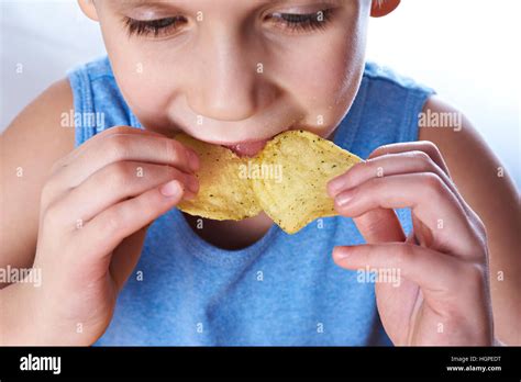 Little boy eating potato chips closeup Stock Photo - Alamy