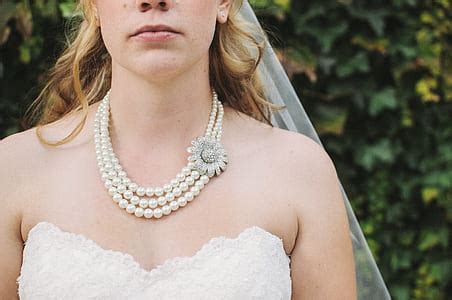 Royalty-Free photo: Silver-colored rings and white pearl necklace | PickPik