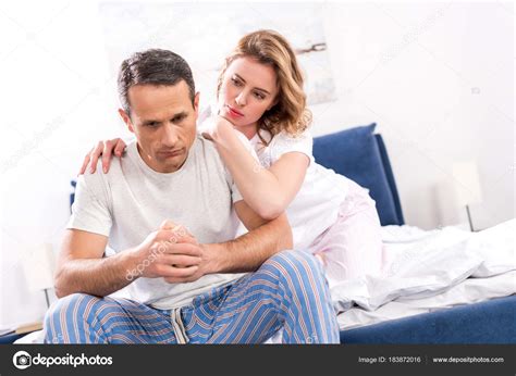 Woman Hugging Sad Husband Sitting Bed Home Stock Photo by ...