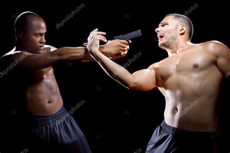 Martial artist disarming criminal with gun — Stock Photo © innovatedcaptures #78768888