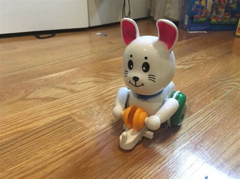 a toy rabbit sitting on top of a wooden floor