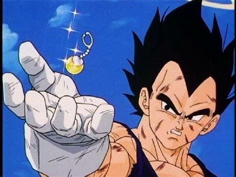 an anime character pointing to the camera with his hand in front of him and a chain hanging from it