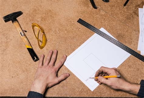 Premium Photo | A carpenter works in a furniture workshop with various tools and a board