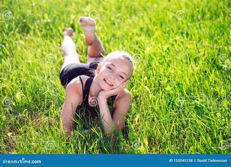 Cute Happy Little Girl Lying on the Grass. Stock Photo - Image of ...