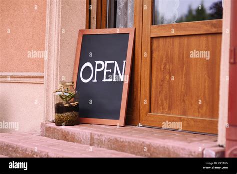 Street cafe, open sign at the door Stock Photo - Alamy