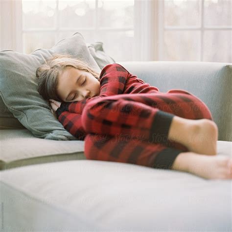 "Cute Young Girl In Pajamas Sleeping On A Big Chair" by Stocksy Contributor "Jakob Lagerstedt ...