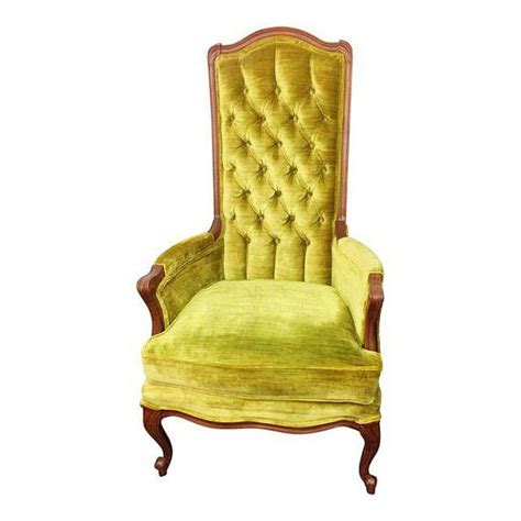 an old fashioned chair with green velvet upholstered on the back and armrests