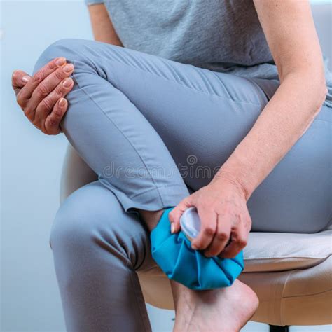 Ankle Pain Treatment. Senior Woman Holding Ice Bag Compress on a Painful Ankle Joint Stock Image ...