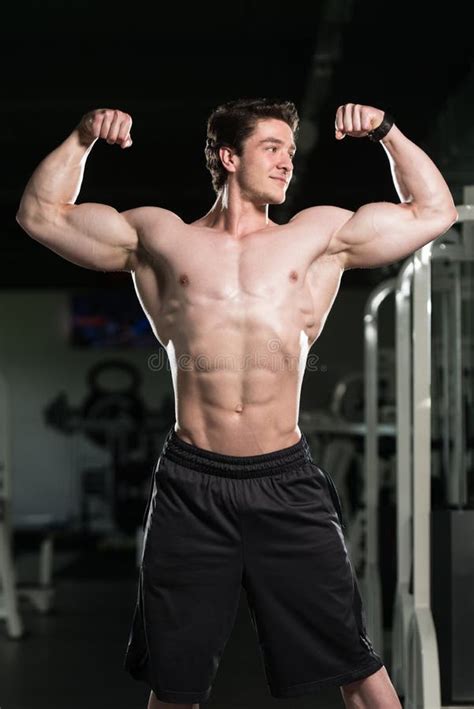 Bodybuilder Performing Front Double Biceps Pose in Gym Stock Photo - Image of human, model: 73366170