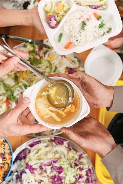 Volunteers giving food to homeless people, top view Stock Photo | Adobe Stock