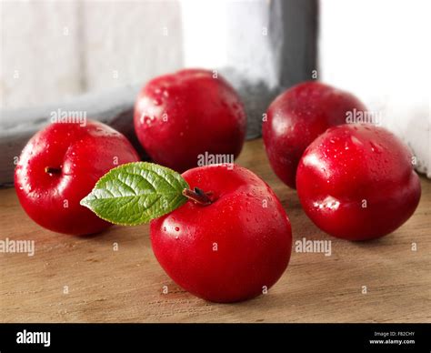 Fresh whole uncooked red Victoria plums in a rustic kitchen Stock Photo - Alamy