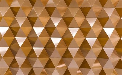 an abstract gold background with triangular shapes and metallic foil on the side, including ...