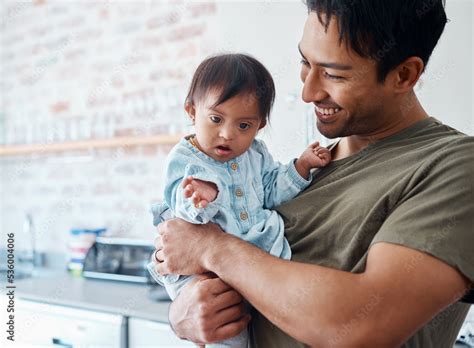 Foto de Down syndrome, baby and father bonding in their home with a proud parent caring for ...