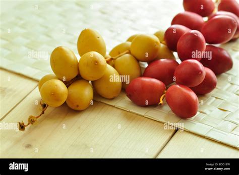 A bunch of red, raw dates on white background Stock Photo - Alamy