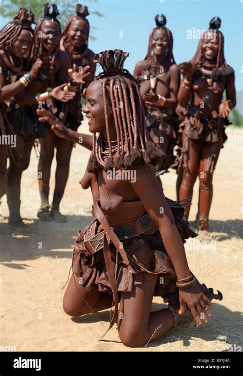 Namibia, Kaokoland. Himba women perform the otjiunda dance, stamping ...